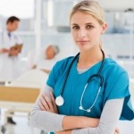Beautiful doctor standing in hospital while his colleagues talki